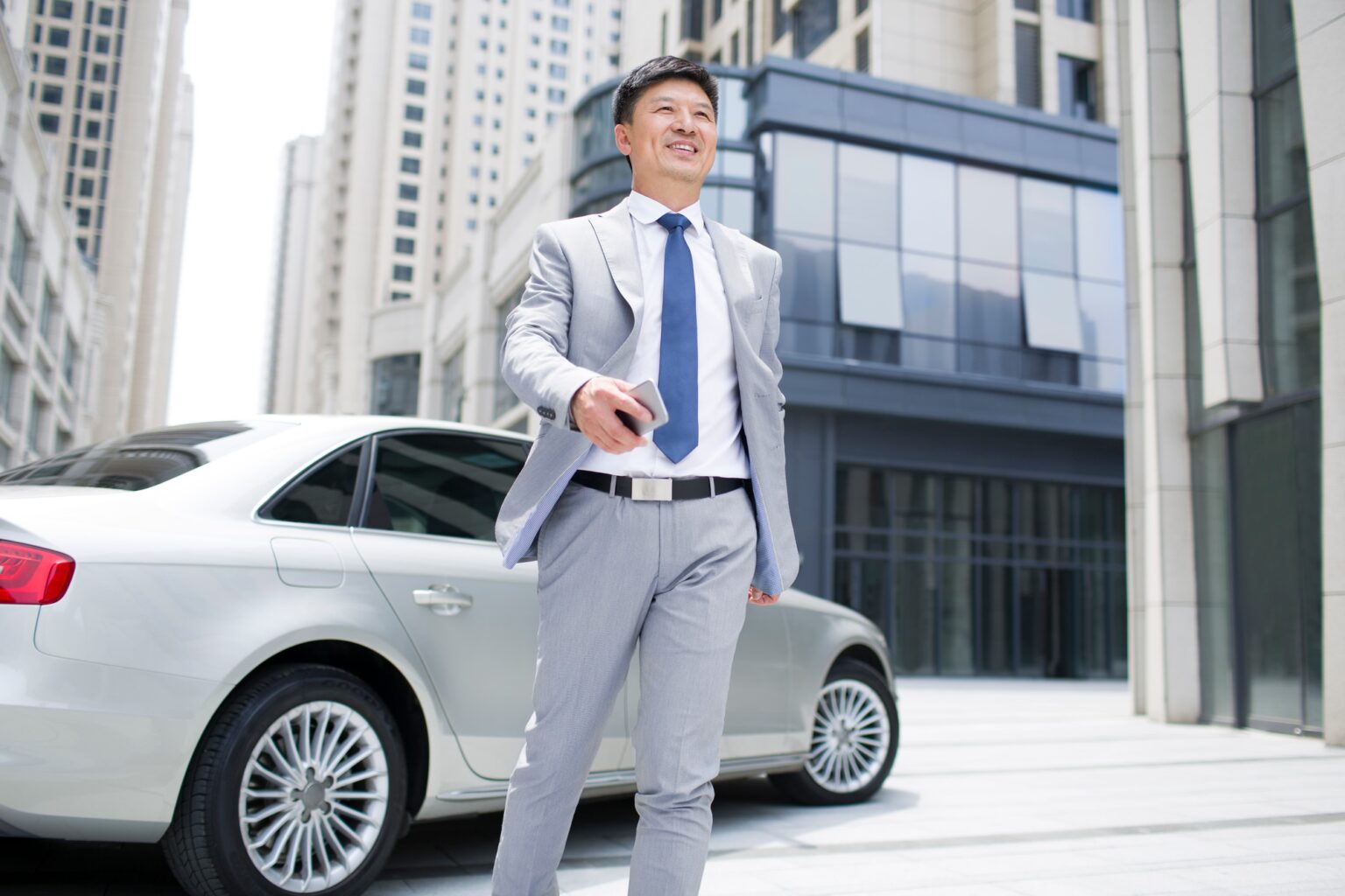 Confident businessman and car