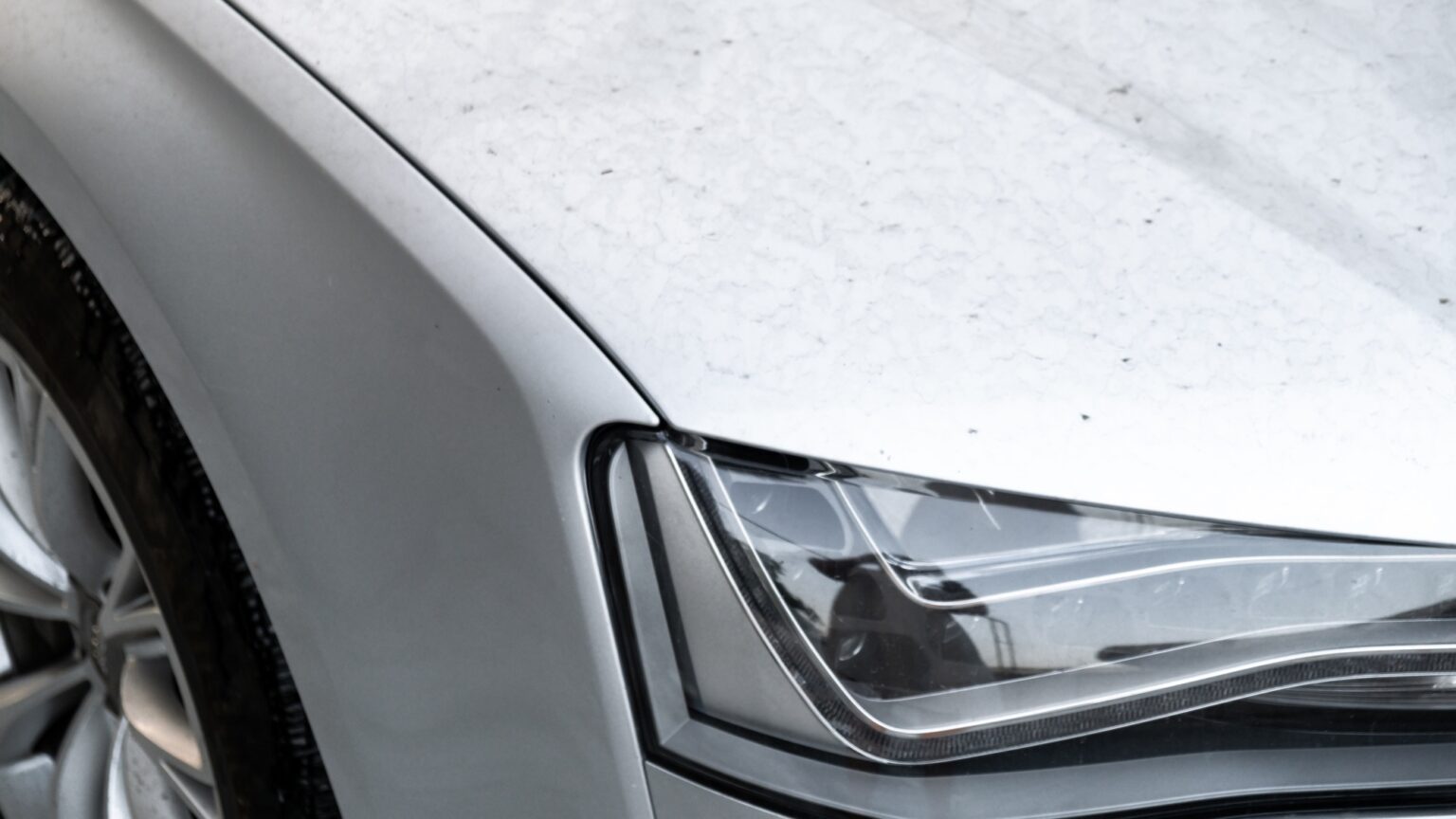Details of dirty car before washing luxury silver car on touchless car wash. Cleaning the details of